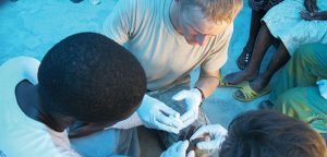 Mike Zaskey treats an infected wound in Haiti, in 2010. Photo courtesy Zaskey.