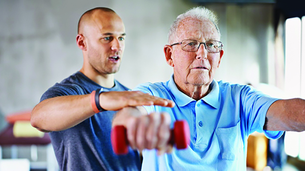 trainer and a man using weights