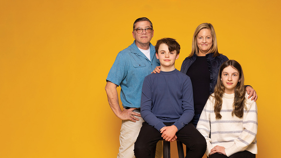 two adults and two children posing for a photo