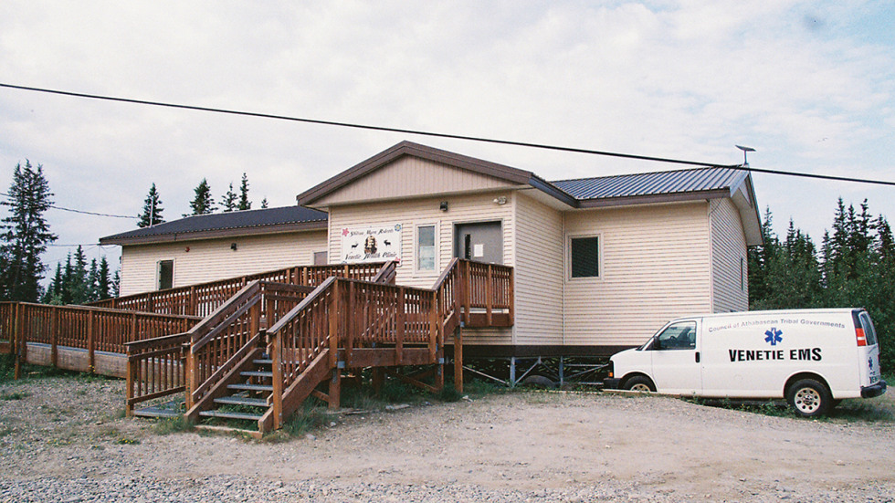 Exterior of health care clinic with a ambulance parked nearby