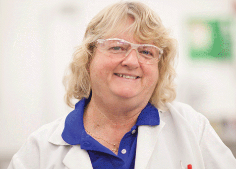 2015: Every day, Kathy Patenaude and her staff make sure all of the teaching labs are set up for the correct section of each course. Armed with rolling metal carts, they lay out the experiments, tools, and materials at the right time for the right instructor. Bet they look forward to summer, right? Nope. That's when thousands of Summer@Brown middle-and high-school students descend, and the whole balletic operation takes on an even faster pace. Patenaude, who has been at Brown for more than 35 years, does it all wearing this smile. (Credit: Erik Gould)