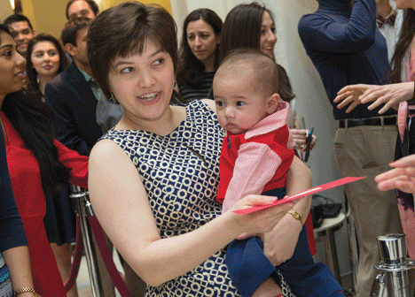 Six-month-old Luke helps his mom, Helen Johnson ’11 MD ’15, collect her envelope.