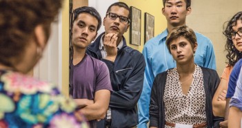 Medical students, including Faiz Khan ’15 MD ’19 (second from left), listen to a patient navigator at Clínica Esperanza. (Credit: Mike Cohea)