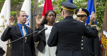 Army second lieutenants and Brown graduates Evan Stern, Uzoamaka Okoro, and Johnathan Davis, left to right, accept their ceremonial commissioning during Commencement weekend in May. Photo by Nicholas Dentamaro