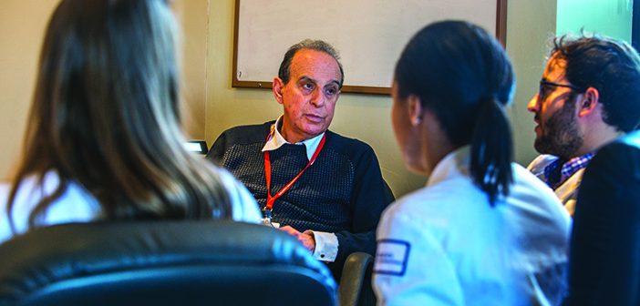 ROUND TABLE: At his weekly journal club at The Miriam Hospital, Ed Feller teaches third-year students how to read and analyze medical literature. Photo by David DelPoio