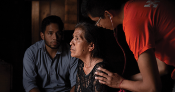 Argel Martínez, left, accompanies first-year physician José Luis Graciliano García, right, during a home visit with Eufemia Aranda Muñoz, a patient of Partners In Health being treated for tuberculosis in rural Chiapas. Photography: Mary Schaad/Partners In Health
